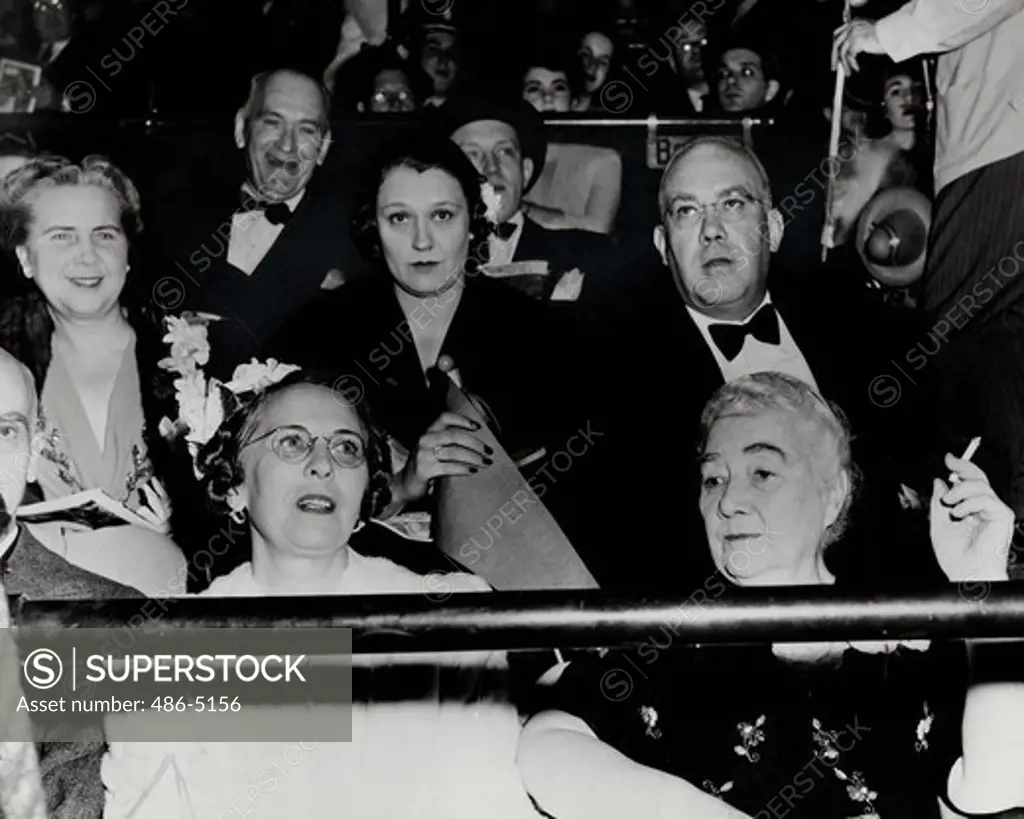 Ringlings family watching circus performance, The Ringlings: never before gathered all together for a circus opening. Front row, Mr and Mrs Robert Ringling, rear Aubrey and Mrs Charles their mother