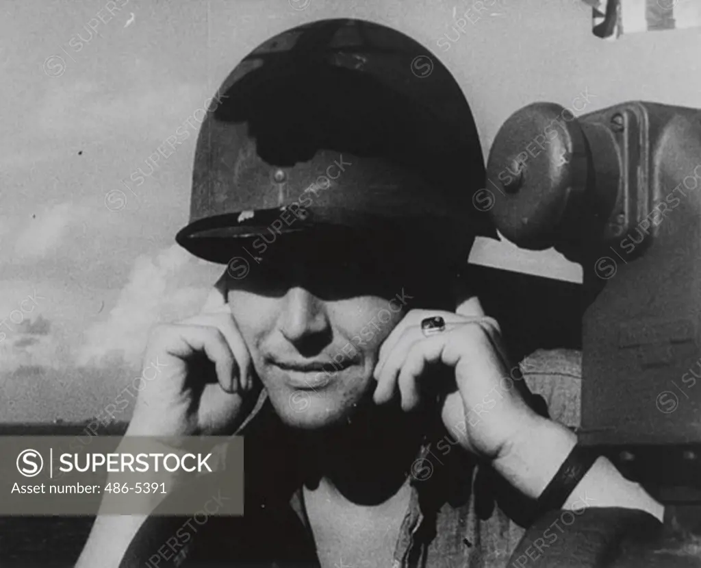 Peleliu, Soldier on warship covering ears for protection, 1945