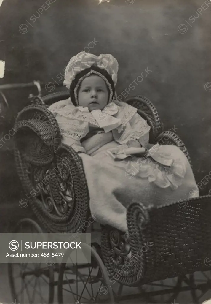 Portrait of baby girl in baby carriage