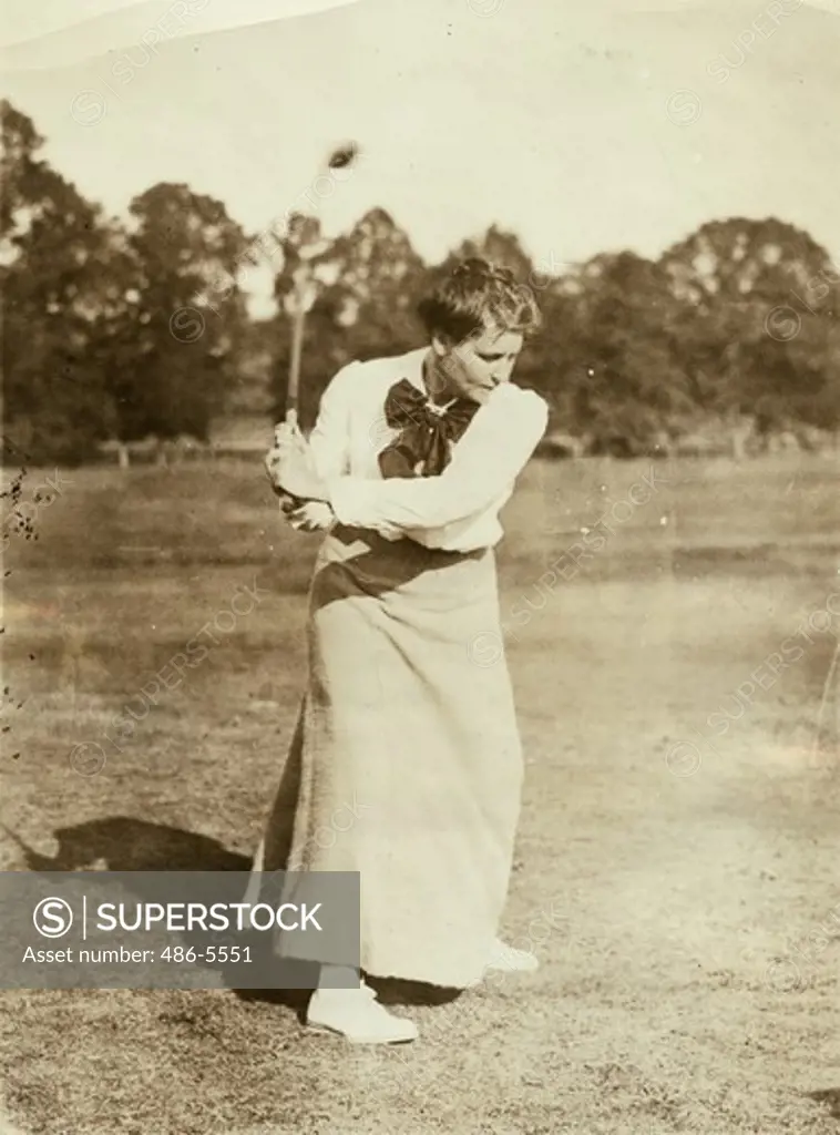 Portrait of young woman golfing