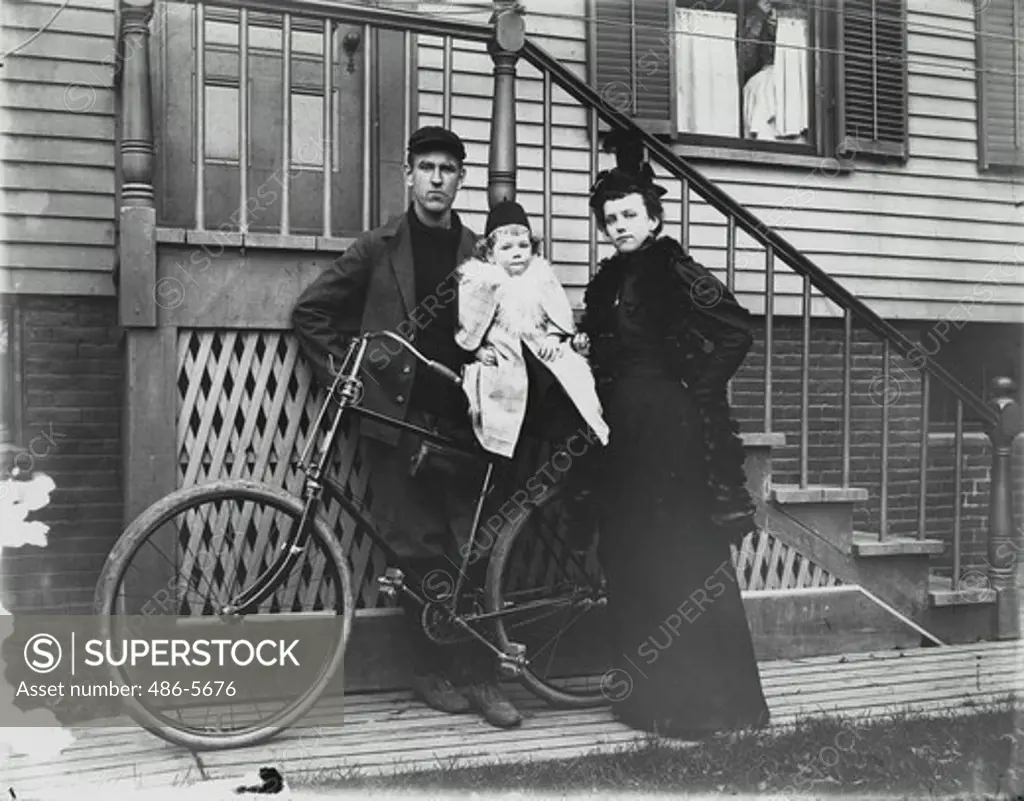 Family in front of house with bicycle