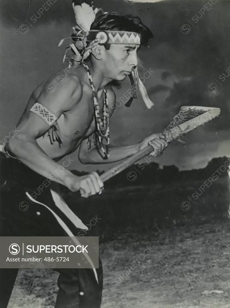 Portrait of member of Onondaga Indian Reservation lacrosse team holding lacrosse stick