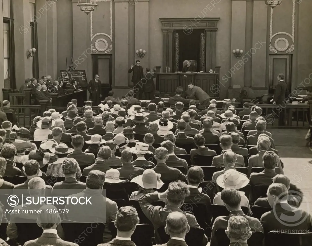 Group of spectators sitting in a courtroom
