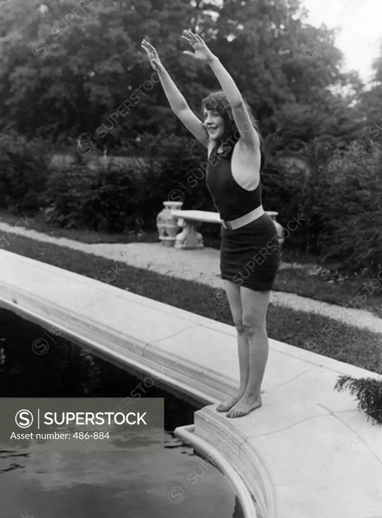 Young woman about to jump into pool