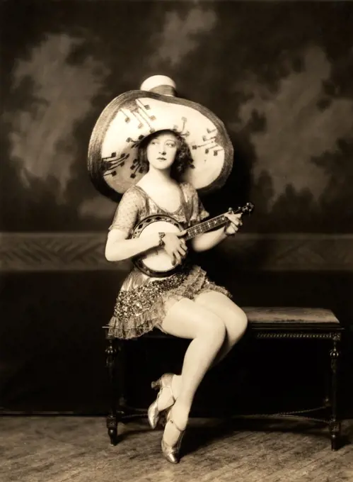 Portrait of woman in hat playing mandolin