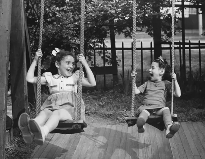 Portrait of girls on swings