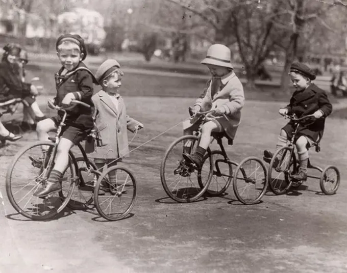 USA, Massachusetts, Boston, Children at play in Boston Public garden playing, Peter Fuller, son of governor in lead bike