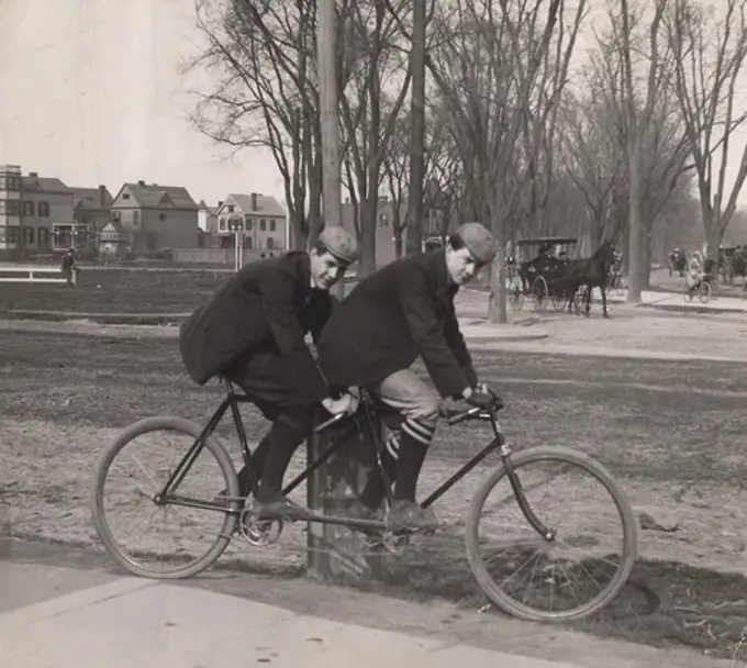 Two men cycling on tandem bicycle