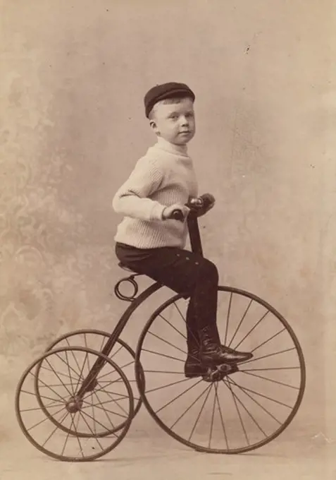 Boy riding tricycle