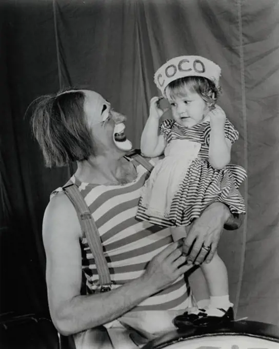 Portrait of Coco Clown with his daughter, Coco the Clown takes time out from his hippodrome hi-jinks to entertain his four year old daughter. The 1965 edition of Ringling Bros. And Barnum & Bailey Circus is the biggest and best of its long history, headlining over 30 brand new European acts and over 100 sensational American Big Top performers.