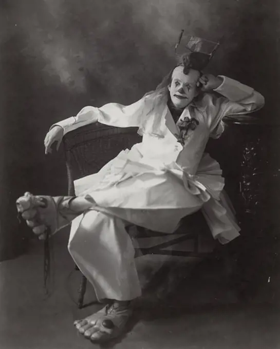 Portrait of clown sitting on chair