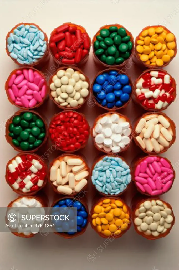 High angle view of an assortment of tablets and capsules in vials