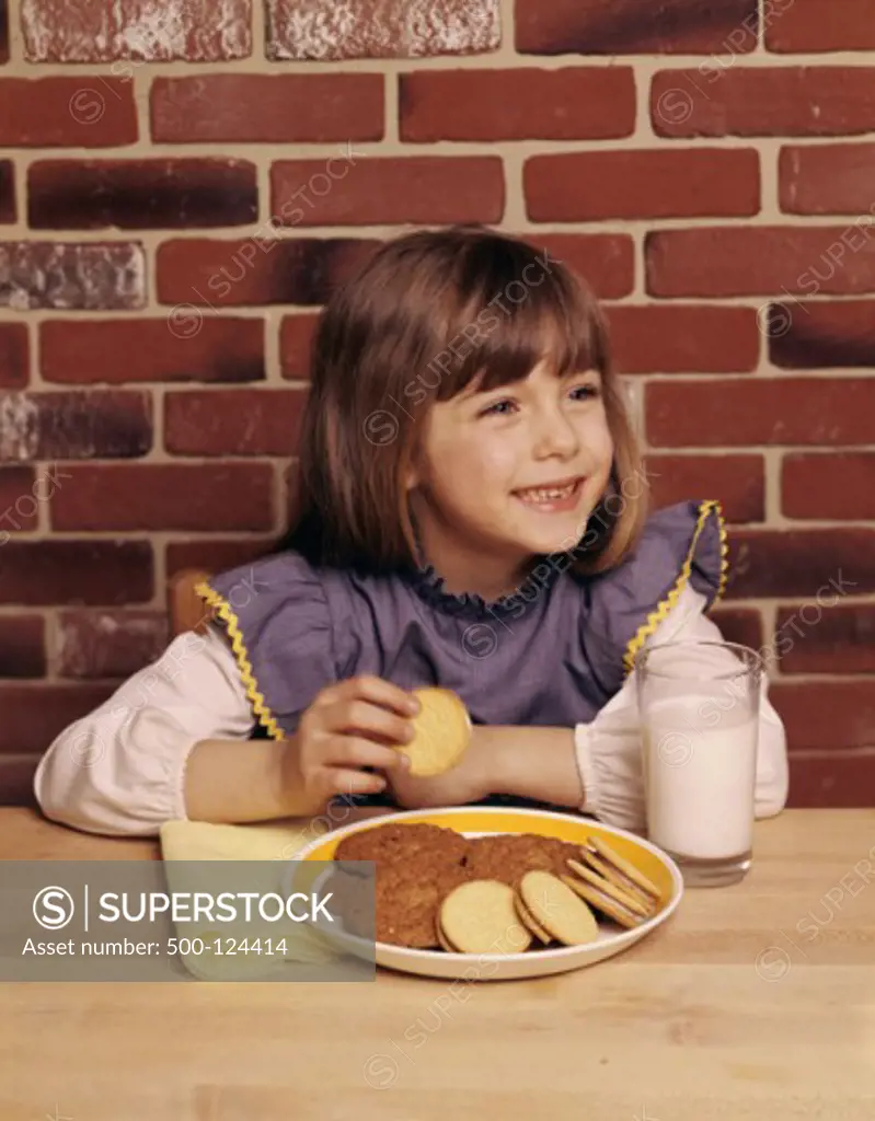 Girl holding a cookie and smiling