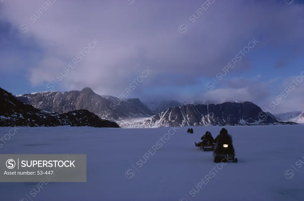 People riding snow mobiles, Arctic, Canada