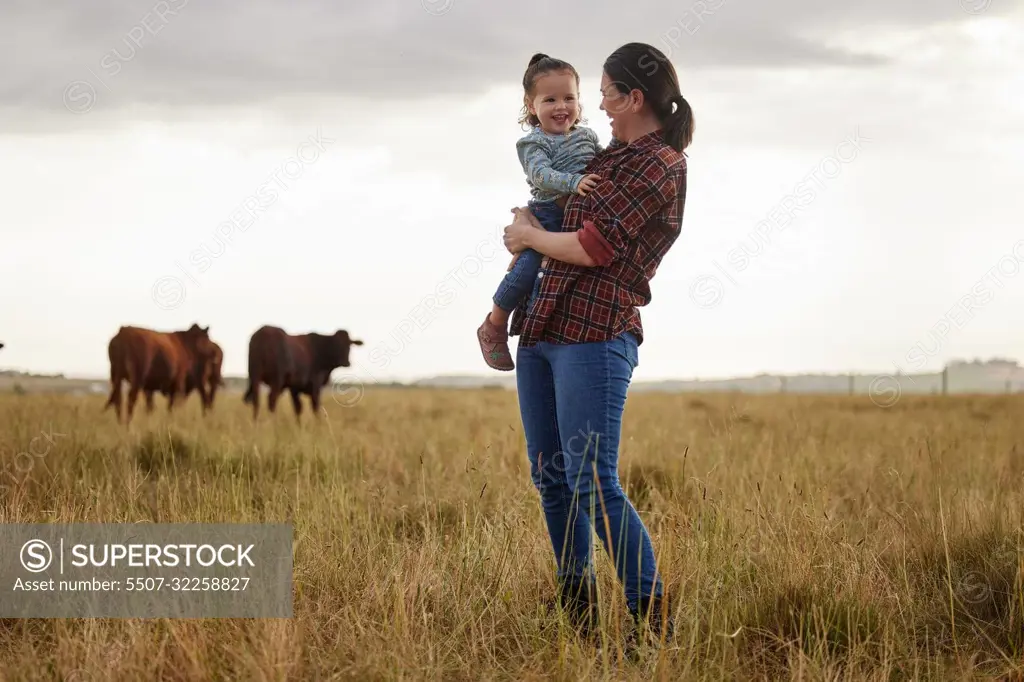 Sustainability, agriculture and countryside farm mother and daughter hug, happy family bonding in nature together. Loving parent and child having fun exploring outdoors, laughing and being playful