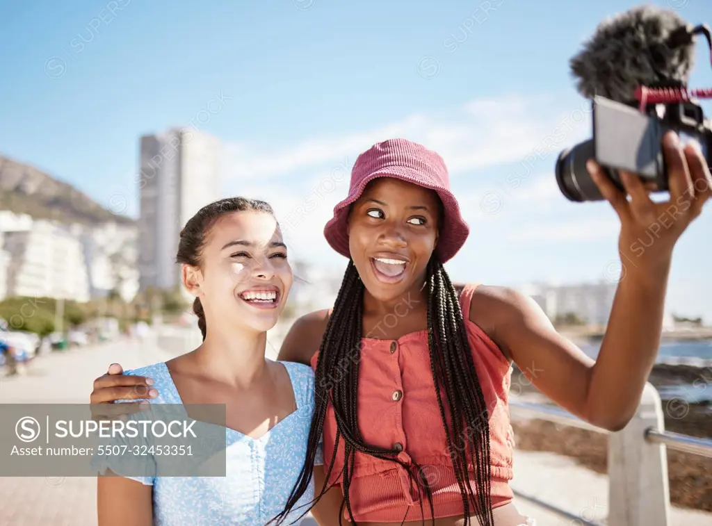 Influencer woman friends on beach live streaming beach holiday or vacation for social media in city, summer and blue sky. Gen z girl couple or people in selfie portrait or outdoor podcast near ocean