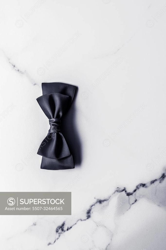 Premium Photo  Black silk ribbon and bow on marble background flatlay