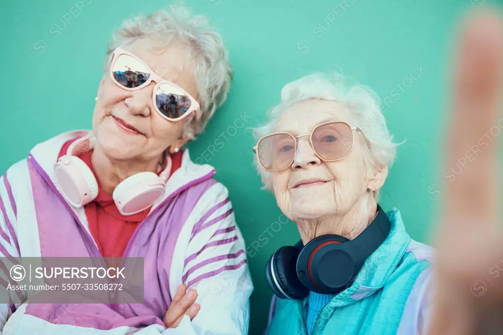 Senior women, fashion and retro selfie with sunglasses, headphones and vintage clothes with cool mindset outdoor. Portrait of aesthetic old people or friends together for pop art profile picture