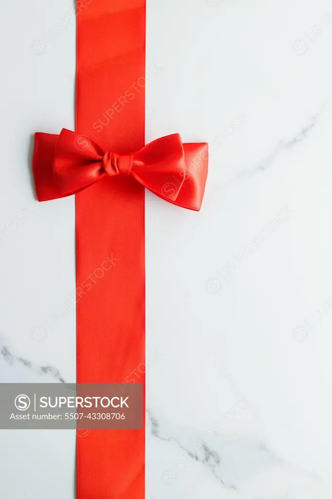 Red silk ribbon on marble, top view - SuperStock