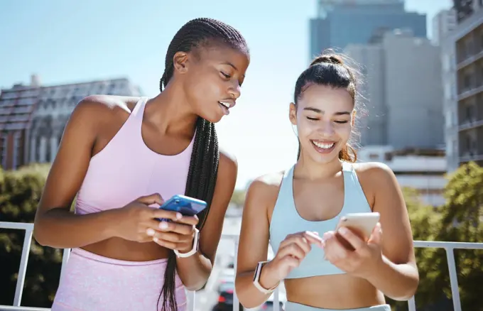 Friends, phone and laughing during exercise for social media, blog or meme while in city together. Women, smartphone and smile with diversity during training, workout or run in Los Angeles in summer