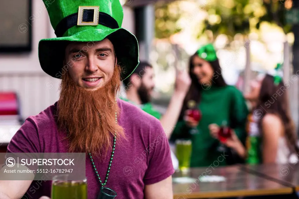 Portrait of man celebrating St Patricks day with a green pint