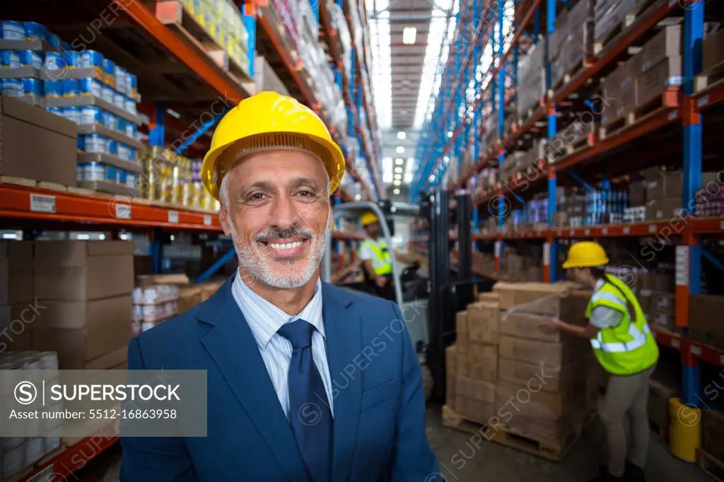Portrait of warehouse manager smiling in warehouse