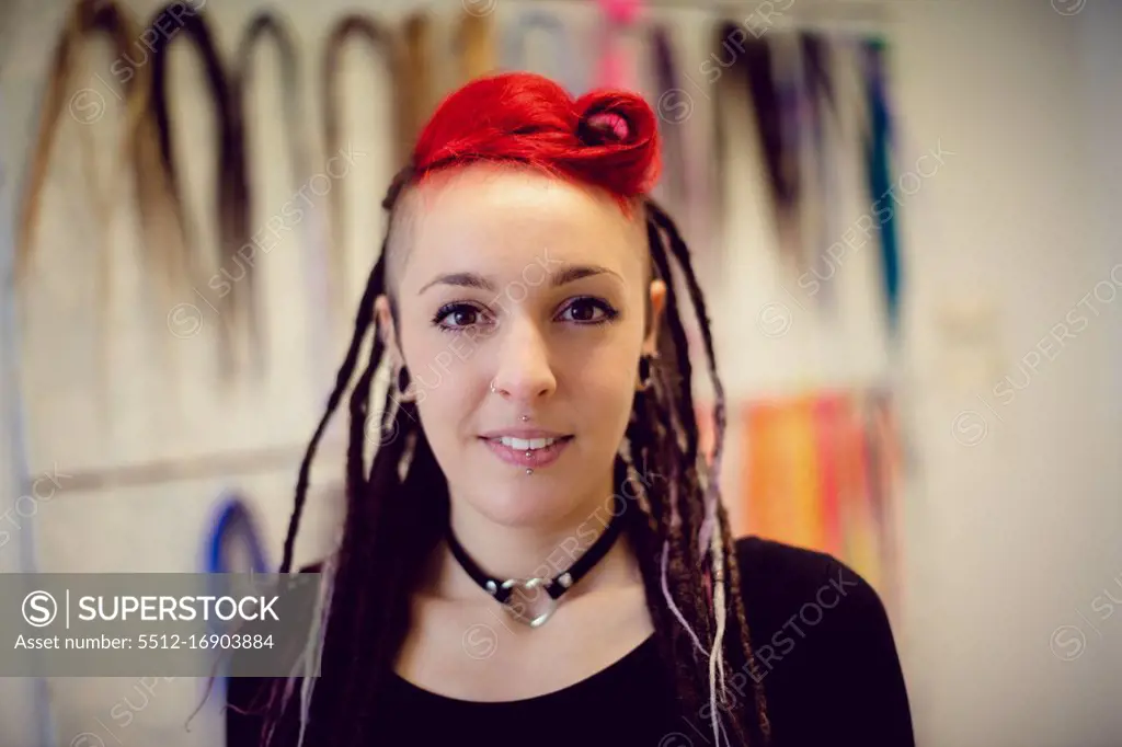 Portrait of female hairdresser in dreadlocks shop