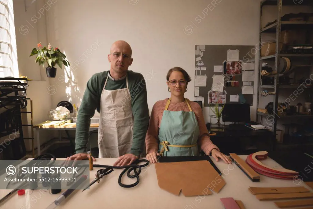 Portrait of male and female worker standing together in workshop