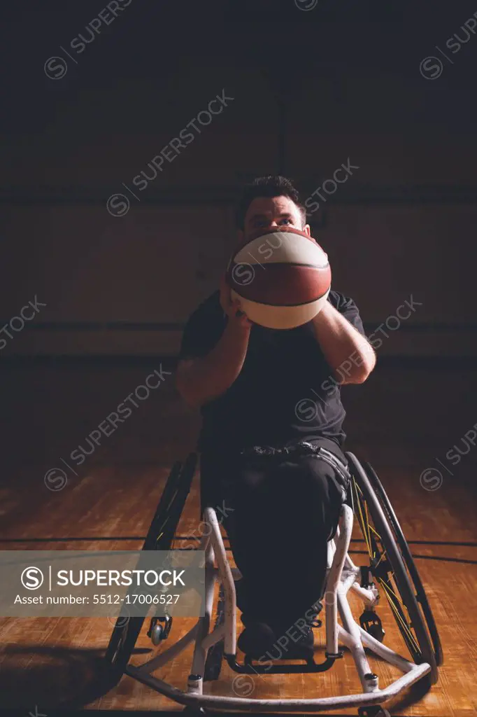 Disabled young man practicing basketball in the court