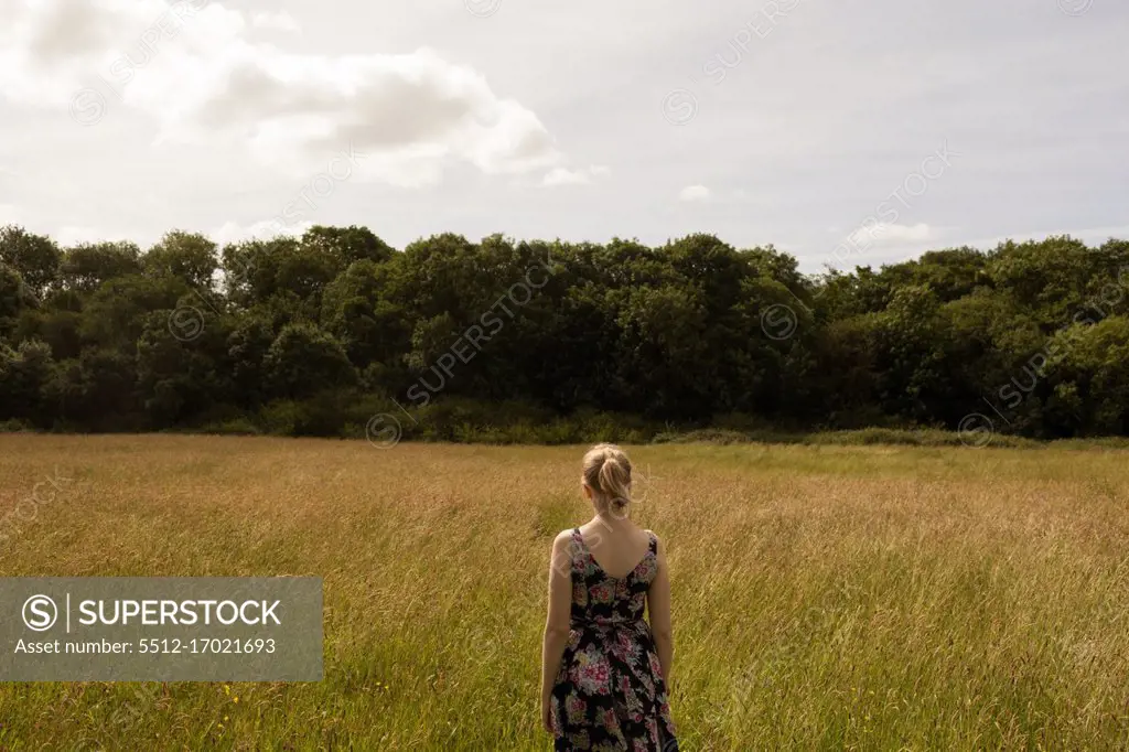 Thoughtful woman standing in the field