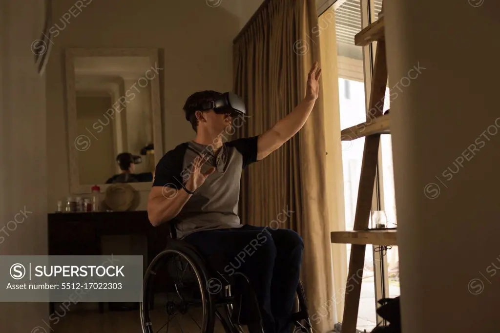 Disabled man using virtual reality headset at home