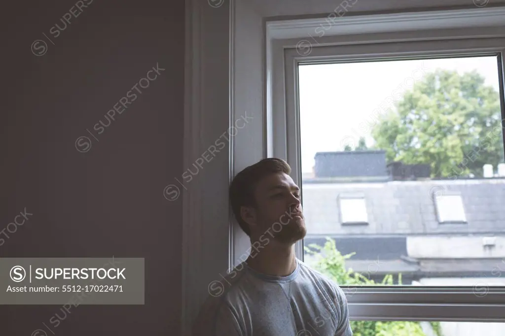 Worried man standing at home