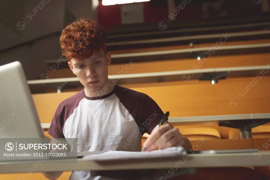 Young college student studying in classroom