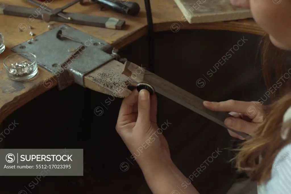 Close-up of jewelry designer working in workshop