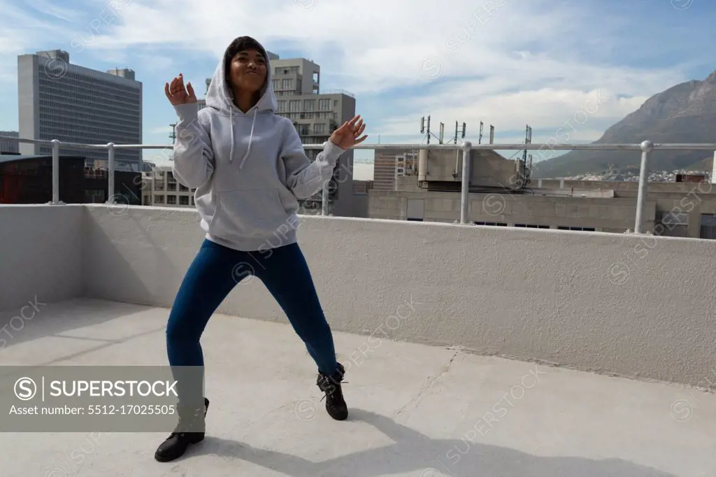 Young model dancing on terrace