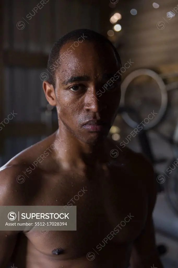 Portrait of male boxer looking at camera in boxing club