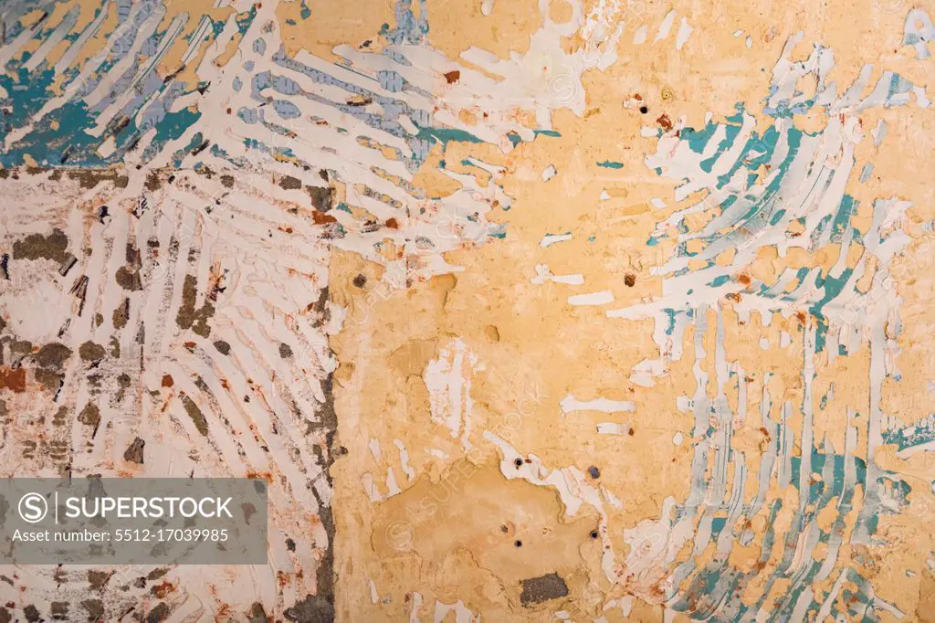 Close up detail of the interior of an abandoned warehouse space showing a distressed wall