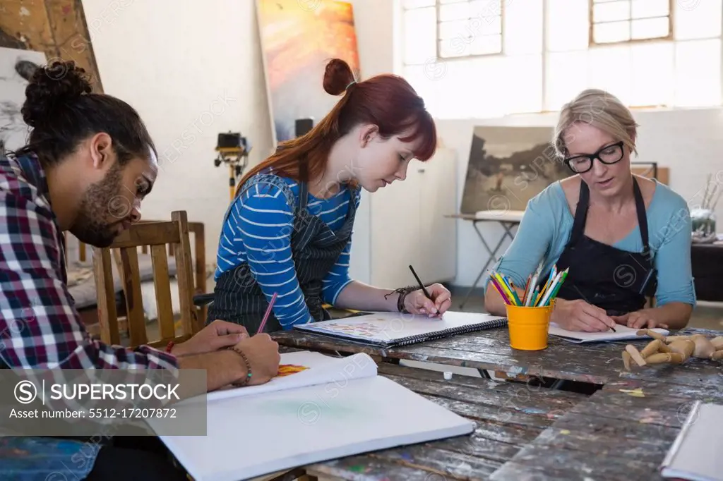 Adult student practicing drawing at table in art class