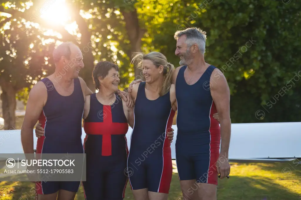Senior caucasian rowing team smiling while standing together in the garden. retirement sports and active senior lifestyle.