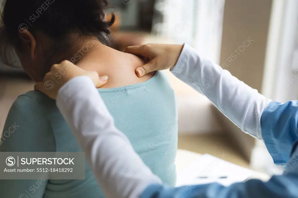 Asian female physiotherapist treating senior female patient at her home. healthcare and medical physiotherapy treatment.
