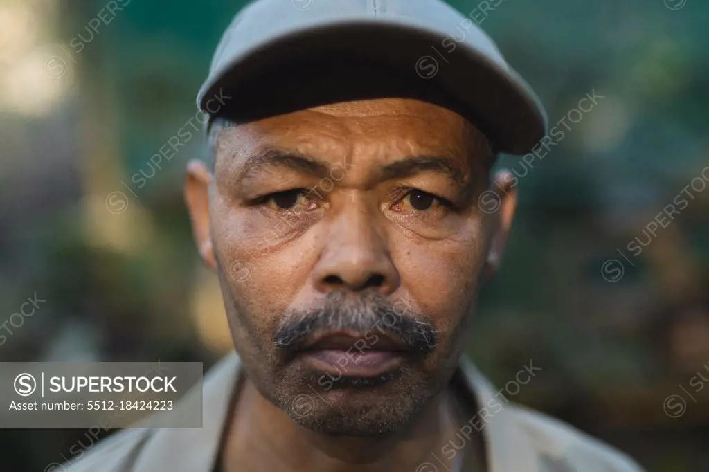 Portrait of african american male gardener looking at camera at garden centre. specialist working at bonsai plant nursery, independent horticulture business.