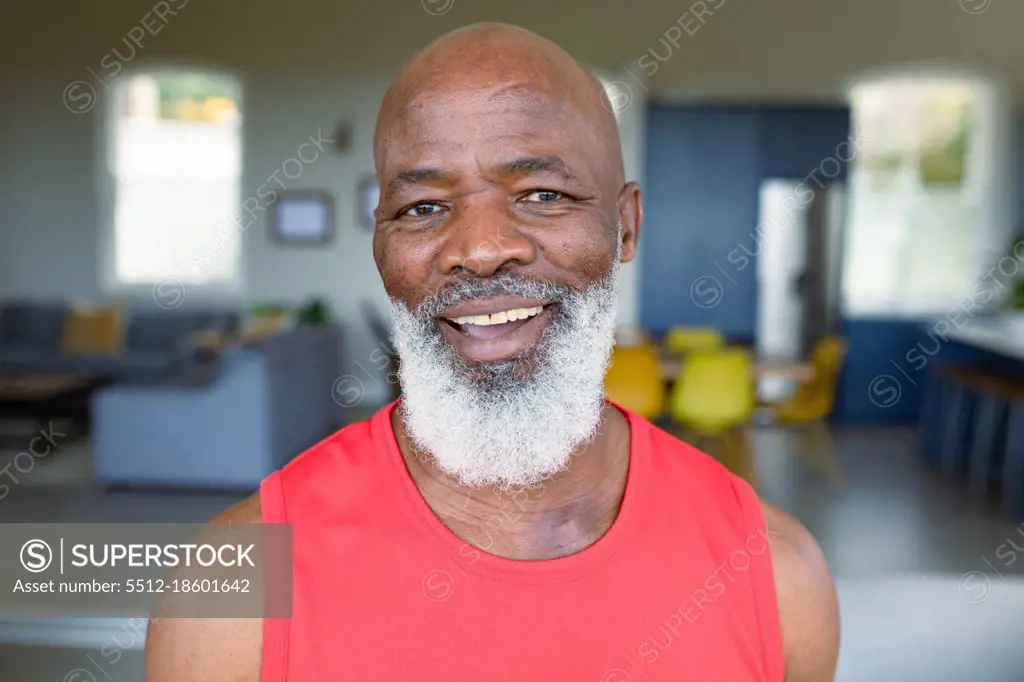 Portrait of happy senior african american man in exercise clothes looking at camera and smiling. healthy, active retirement lifestyle at home.