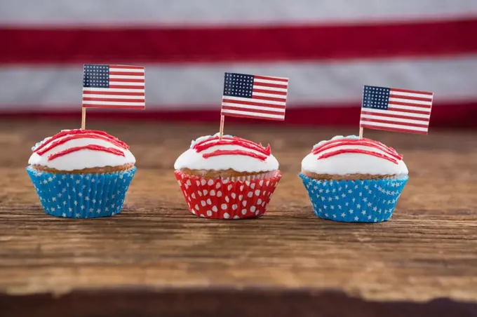 Close-up of patriotic cupcake with American flag on wooden table