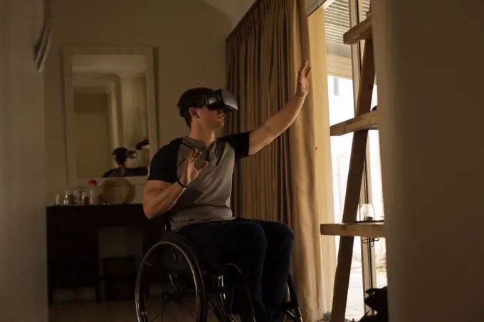 Disabled man using virtual reality headset at home