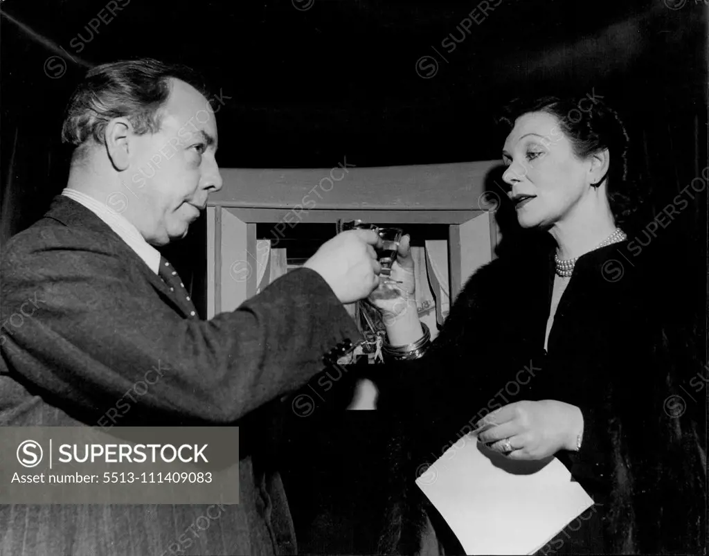 J.B. Priestley's "High Toby" -- A toast to the Toy Theatre : Mr. Priestley clinks glasses with Miss Doris Zinkeisen the famous London stage designer who was responsible for the charming sets of the little stage. April 11, 1949. (Photo by Tom L. Blau, Camera Press).