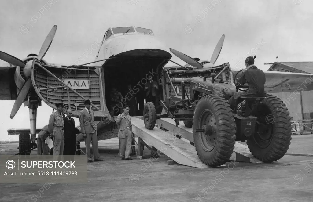 Huge Road Grader, weighing 9264lb., being driven into an ANA Bristol airfreighted at Essendon today for transport to Flinders Island. The grader is the heaviest single lift ever made by air in the Commonwealth. January 11, 1950.