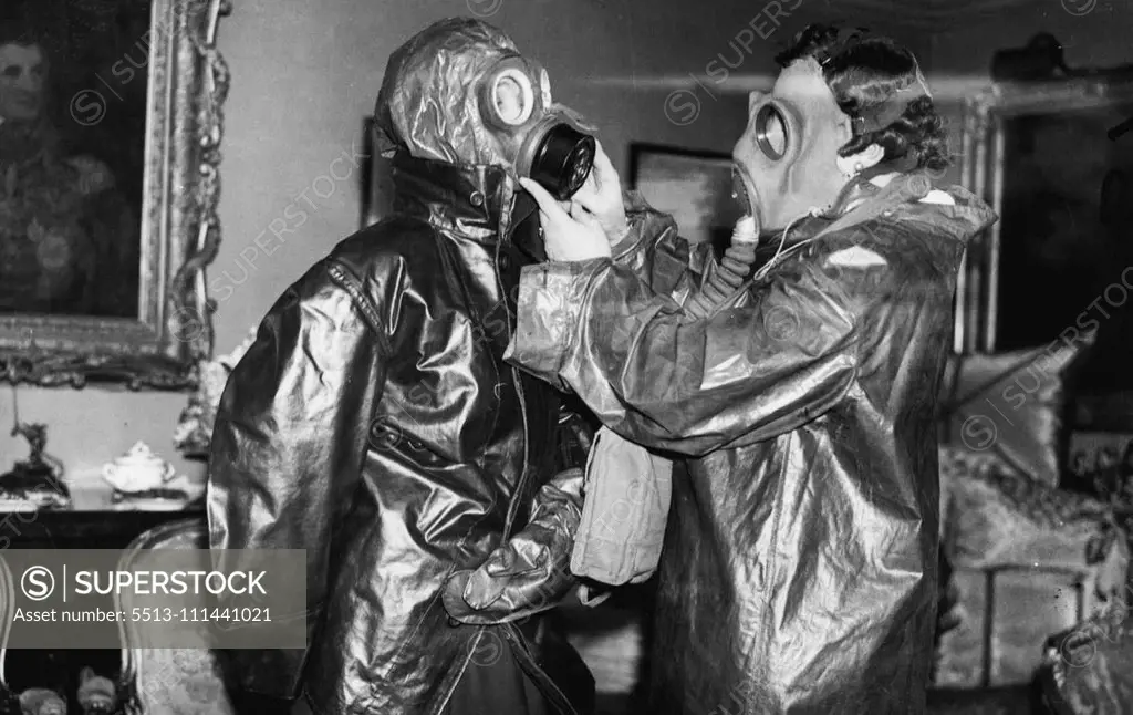 Mayfair Tea Party In Gasmasks - Mrs.Fitzmaurice Of Orkney, and Lady Elibank. Society ladies at a Mayfair tea party donned gasmasks and decontamination clothes when they were instructed on Air Raid precautions and shown to use the equipment, The demonstration was arranged by Mrs.Fitzmaurice of Anna, one of the most energetic of the A.H.P. workers in social circles,and Mr.White Knox. April 4, 1938. (Photo by London News Agency Photos Ltd.).