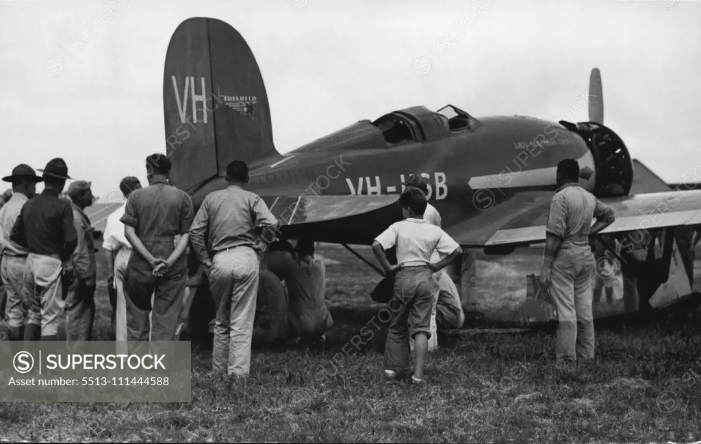 Skilled mechanics at Wheeler Field, U.S. Army airport, working on the "Lady Southern Cross" just as enthusiastically and willingly as they would have if she had been flown by American fliers. December 24, 1934.