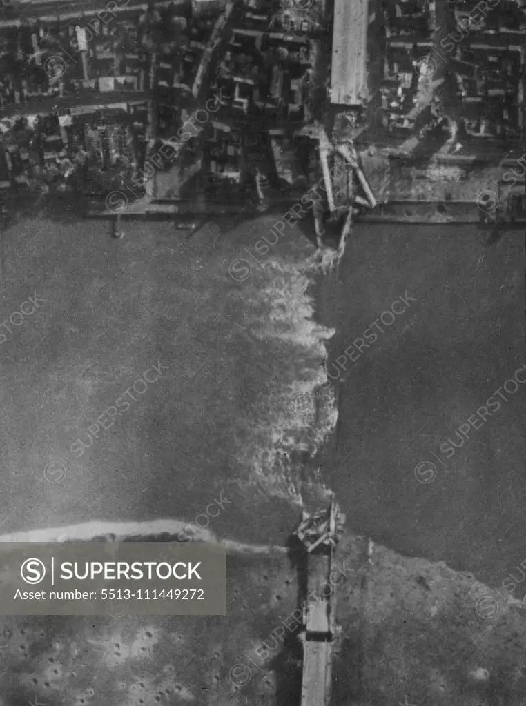 R.A.F. Attack On Cologne Of 28/10/44. Another RAF. reconnaissance picture taken after the attack of 28/10/44. Shows the large highway suspension bridge which was completely demolished. Cologne, worst damaged city in the whole of the Ruhr and Rhineland, was given its heaviest attack of the whole war by RAF. Bomber Command in the daylight attack of 28/10/44. Lancasters and Halifaxes dropped a great weight of high explosives and incendiary bombs on the railway and industrial city. The bombers were 