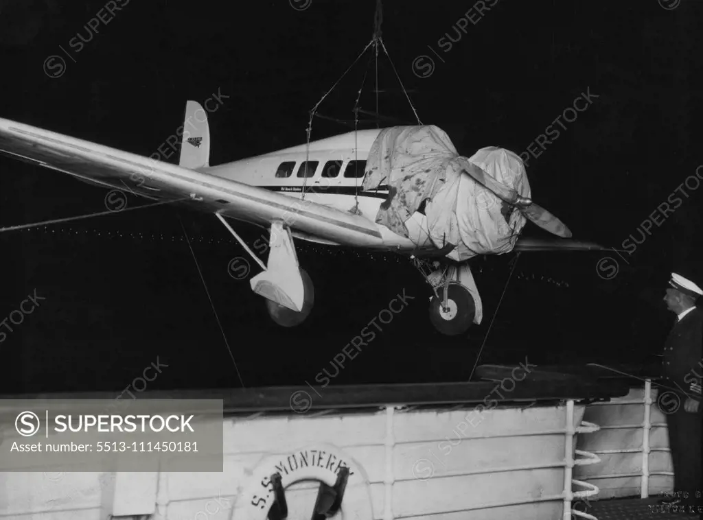Fastest 'Plane In Australia -- Unloading a Lockheed Orion, capable of 220 m.p.h. from the liner "Monterey" at midnight last night. This machine, flown by Captain J.P. Dickson, accompanied by Mr. Arthur M. Loew, First Vice President Metro-Goldwyn Mayer Pictures, and Mr. Rosthal, will fly to Melbourne Saturday, Adelaide Monday, Wyndham Tuesday, thence depart on the biggest commercial world flight yet undertaken. Vacuum Oil Company have arranged supplies. Lights of Sydney harbour bridge can be seen